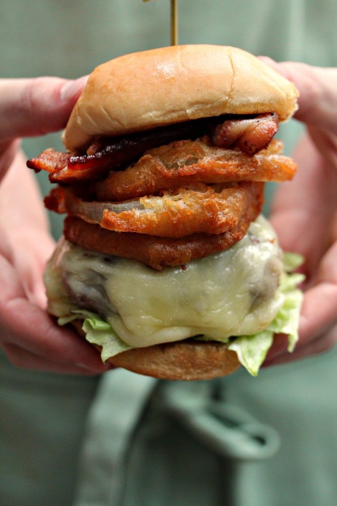 Onion Ring Cheeseburger held in hands