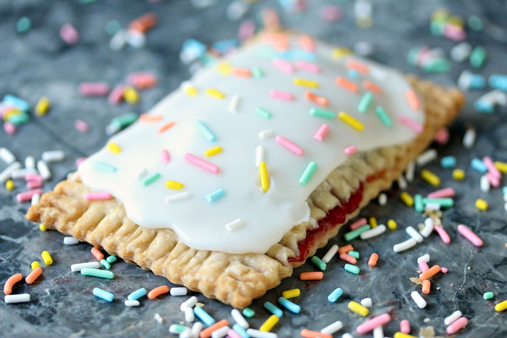 Easy Semi-Homemade Strawberry Pop Tarts on counter with sprinkles spilled all over