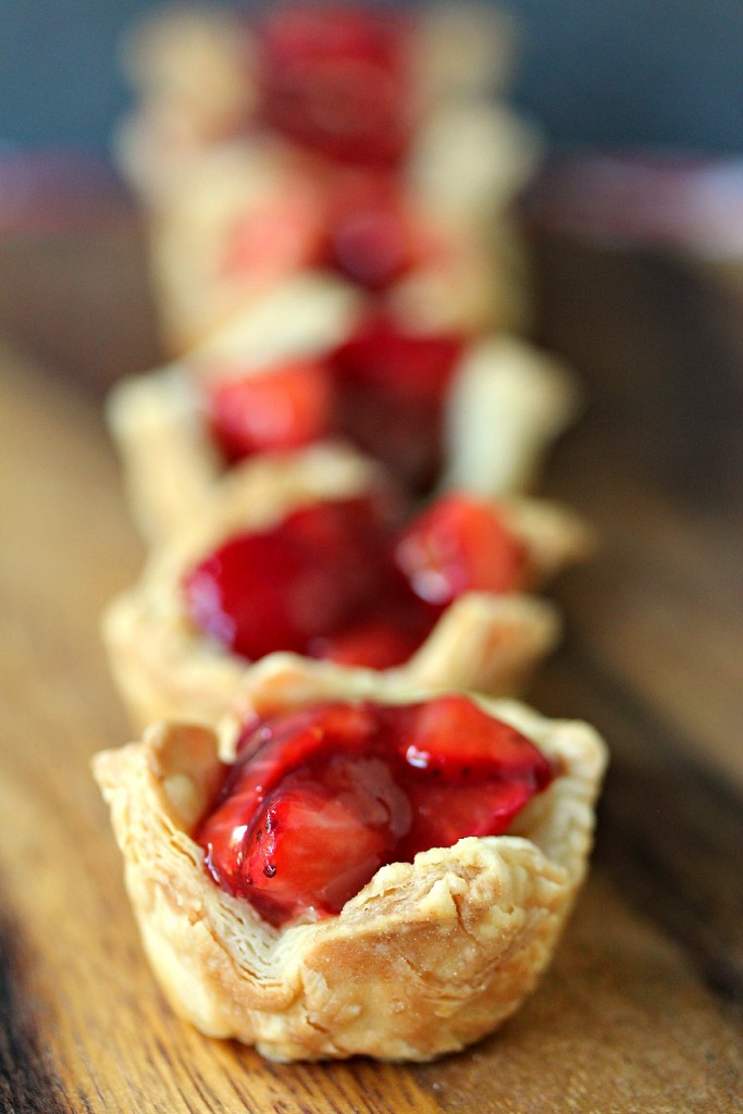 Strawberry Filled Mini Puff Pastries on a wooden board