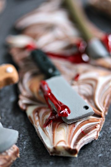 Chocolate Weapons Bark pieces on a dark surface.