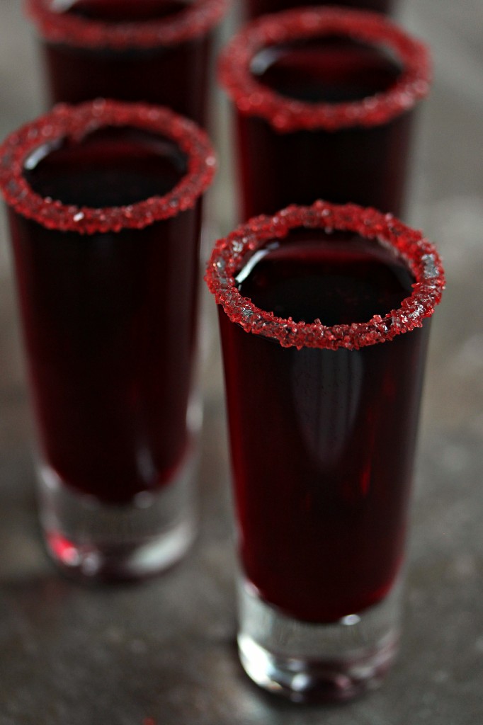 Tall shot glasses filled with pomegranate "walker blood" sangria. 
