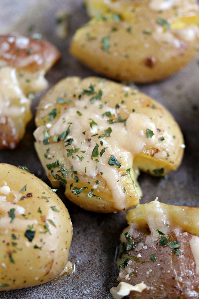 Parmesan Smashed Potatoes topped with fresh parsley.