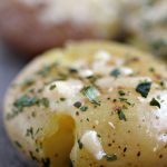 Parmesan Smashed Potatoes cooked to perfection and topped with fresh parsley.