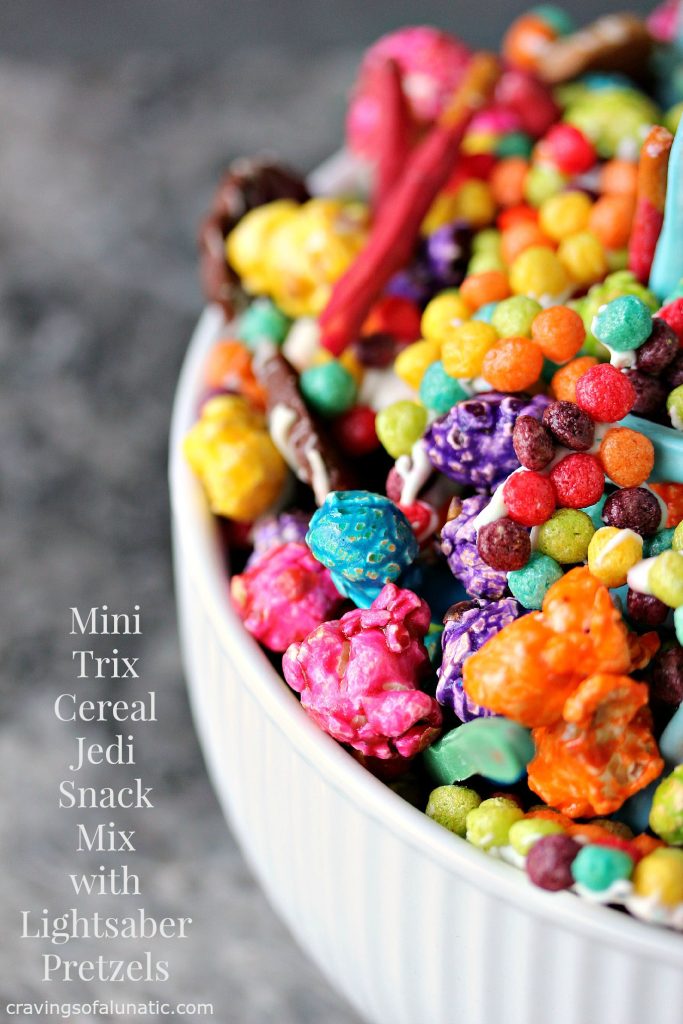 Mini Trix Cereal Jedi Snack Mix with Lightsaber Pretzels by cravingsofalunatic.com- This Jedi Snack Mix uses Mini Trix Cereal, Pretzels made into Lightsabers, coloured popcorn, tiny wafer cookies and M&M Candies. It's the perfect snack for the premiere of Star Wars: The Force Awakens! May the force be with you! (@CravingsLunatic)
