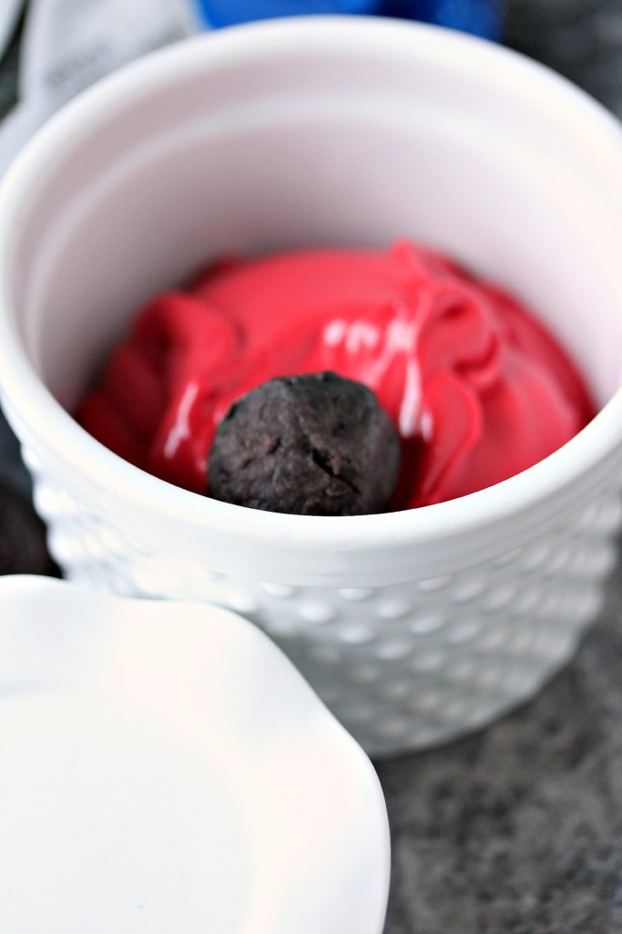 OREO Cookie Balls being rolled in red chocolate