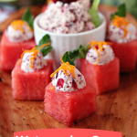 Watermelon Cups with Cranberry Mascarpone on a wooden tray with a white bowl of the mascarpone on it.