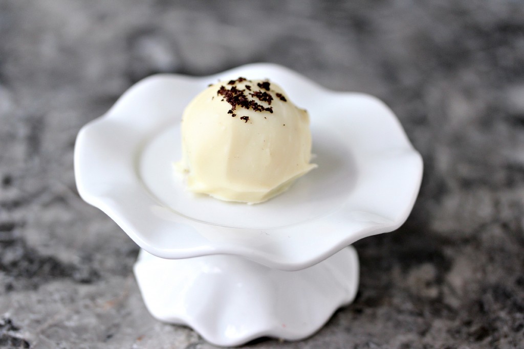 white chocolate oreo cookie ball on a tiny white serving dish