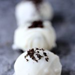 No Bake White Chocolate Oreo Cookie Balls on a grey marble surface.