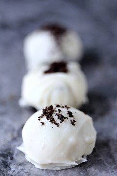 No Bake White Chocolate Oreo Cookie Balls on a grey marble surface.