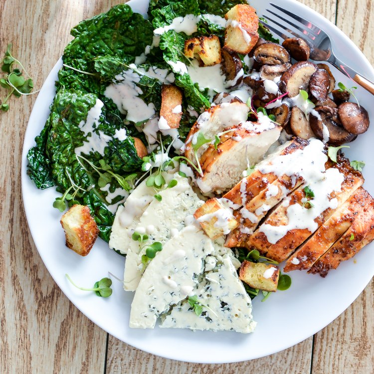 Overhead image of Charred Kale Caesar Salad with Honey Chipotle Chicken on a white plate