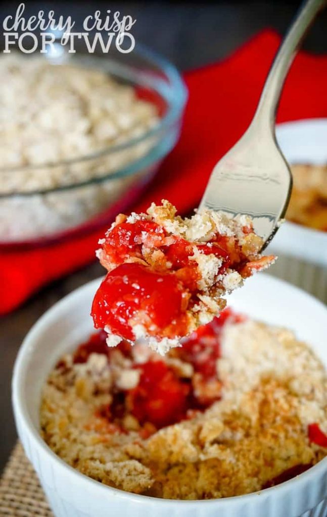 Cherry Crisp for Two from The Love Nerds  in a white bowl with a spoon digging into it