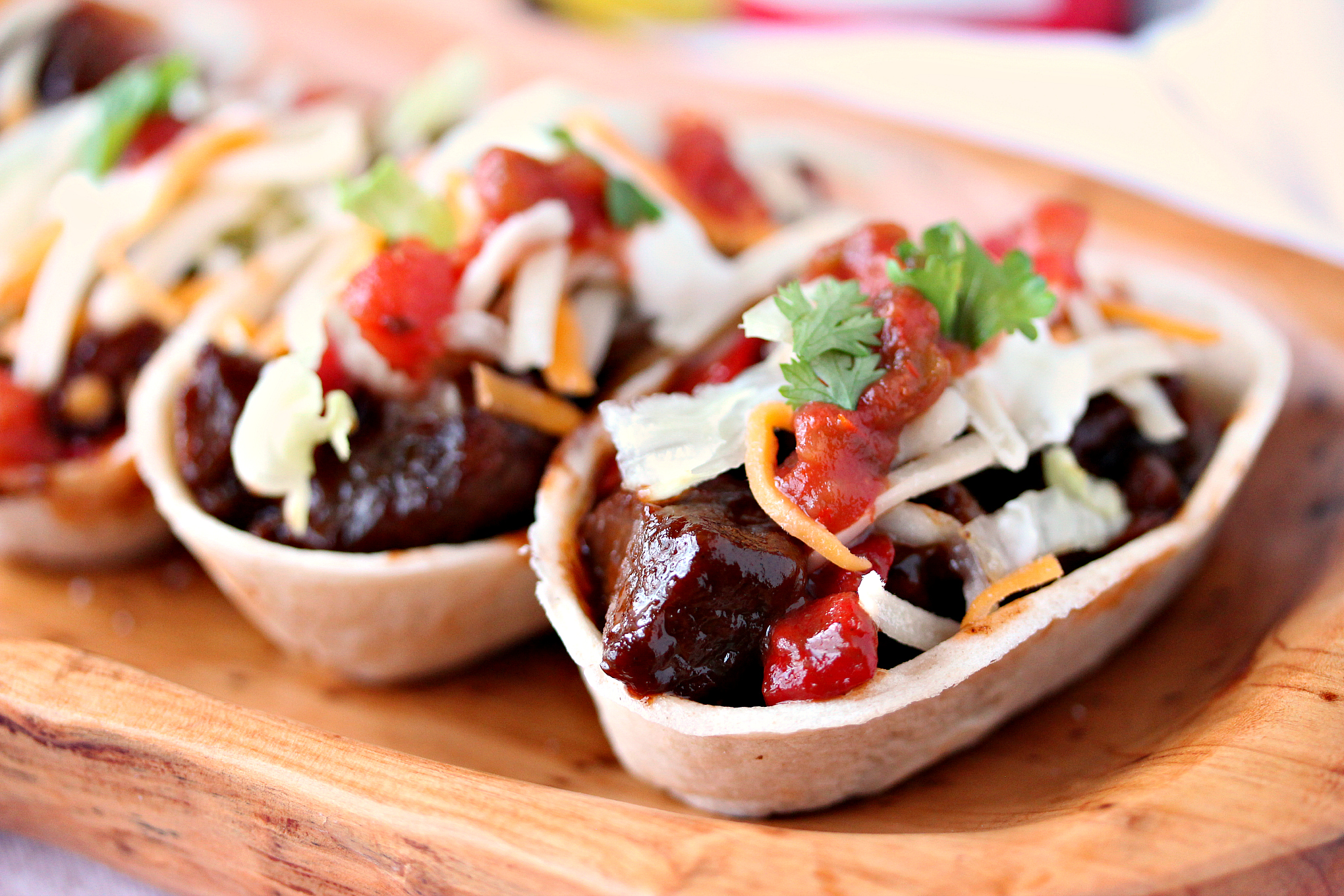 Steak Bites Mini Taco Boats from cravingsofalunatic.com- This taco recipe uses steak marinated in beer, then cooked to perfection in a cast iron skillet, and topped with Barbecue Sauce. It's Tex-Mex in mini form. Every bite is full of flavour. (@CravingsLunatic)