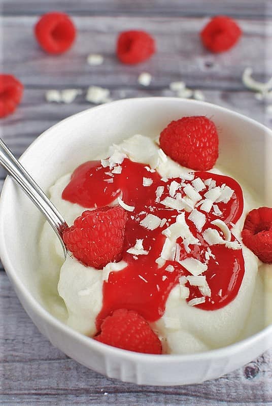White Chocolate Mousse with Raspberry Sauce from Fake Ginger served in a white bowl