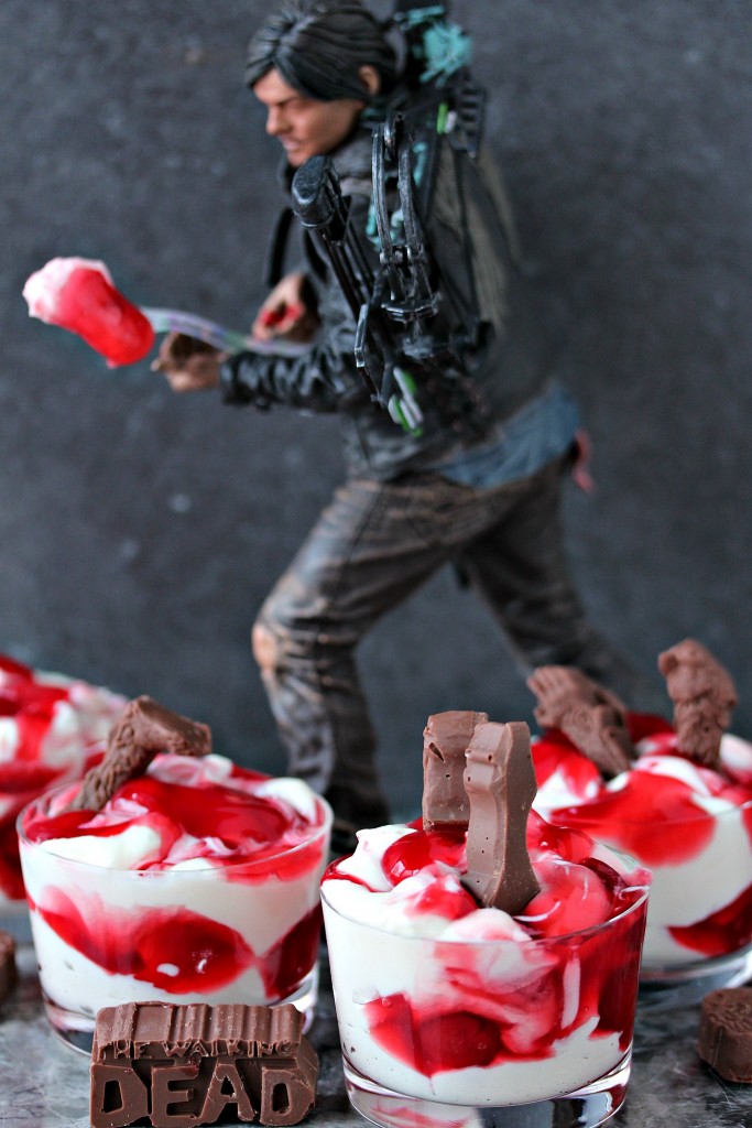 cherry dip in glass dishes with a statue of daryl dixon holding a chocolate piece