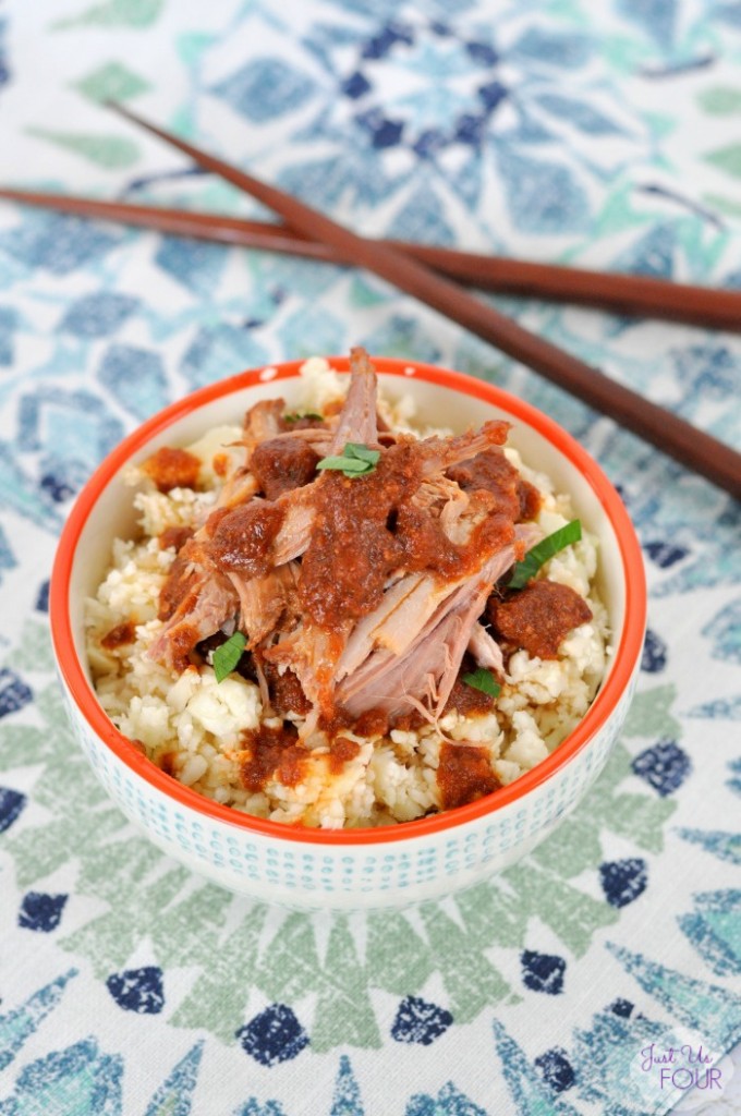 Slow Cooker Chinese Pork – Just Us Four image of recipe in white and orange bowl on a multi-coloured napkin with chopsticks nearby. 