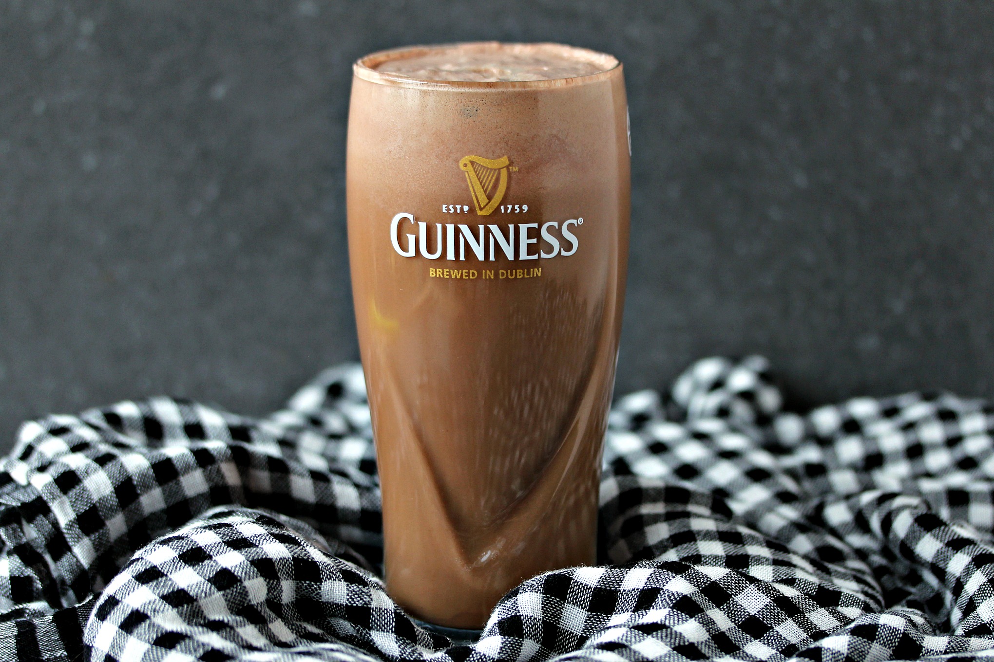 Chocolate Guinness Float served in a tall glass on a houndstooth fabric napkin