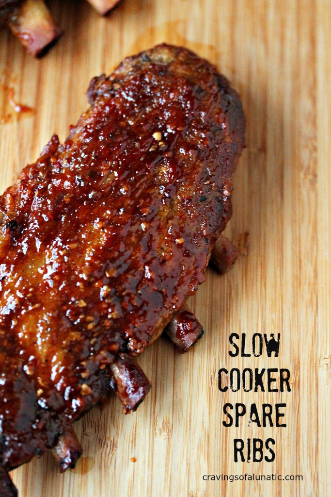 Slow Cooker Spare Ribs cooked to perfection and resting on a wooden cutting board. 