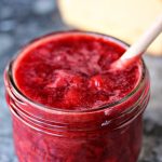 3 Ingredient Strawberry Compote in a mason jar with a wooden spoon