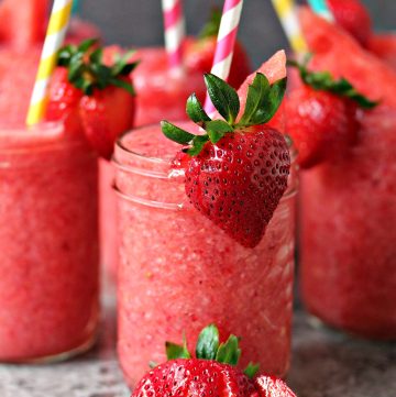 Boozy Strawberry Watermelon Slushies served in mason jars