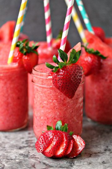 Boozy Strawberry Watermelon Slushies served in mason jars
