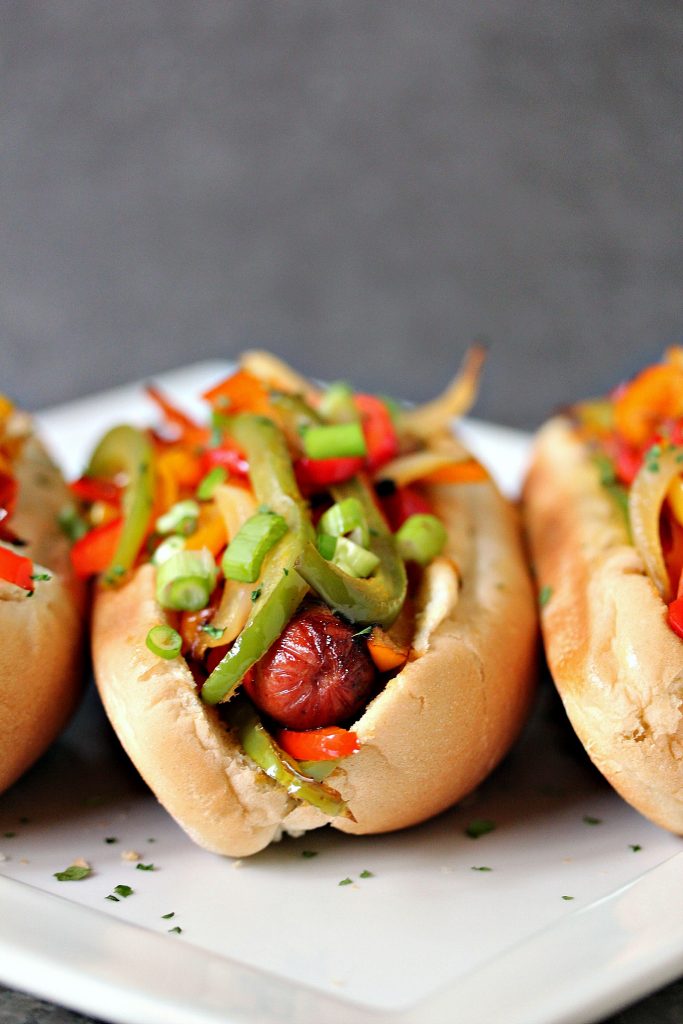 Grilled Fajita Hot Dogs topped with bell peppers and onions. This recipe is incredibly easy to make, yet bursting with flavour. Be a legend at your grill this summer! 