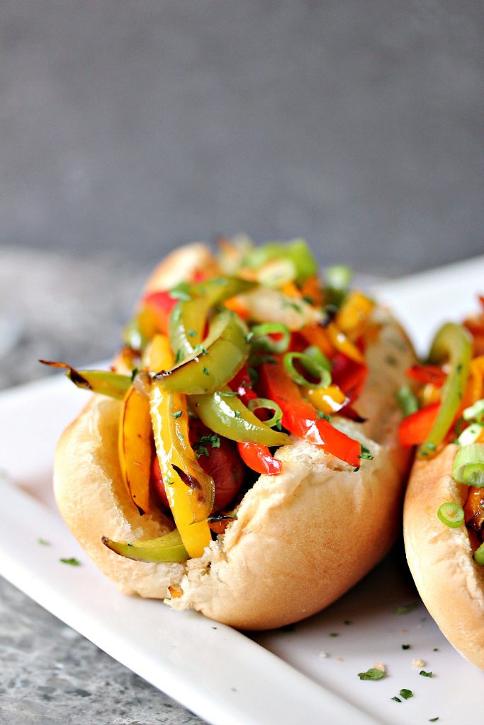 Grilled Fajita Hot Dogs topped with bell peppers and onions. This recipe is incredibly easy to make, yet bursting with flavour. Be a legend at your grill this summer! 