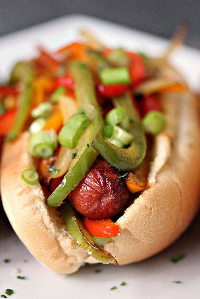 Grilled Fajita Hot Dogs topped with bell peppers and onions. This recipe is incredibly easy to make, yet bursting with flavour. Be a legend at your grill this summer!