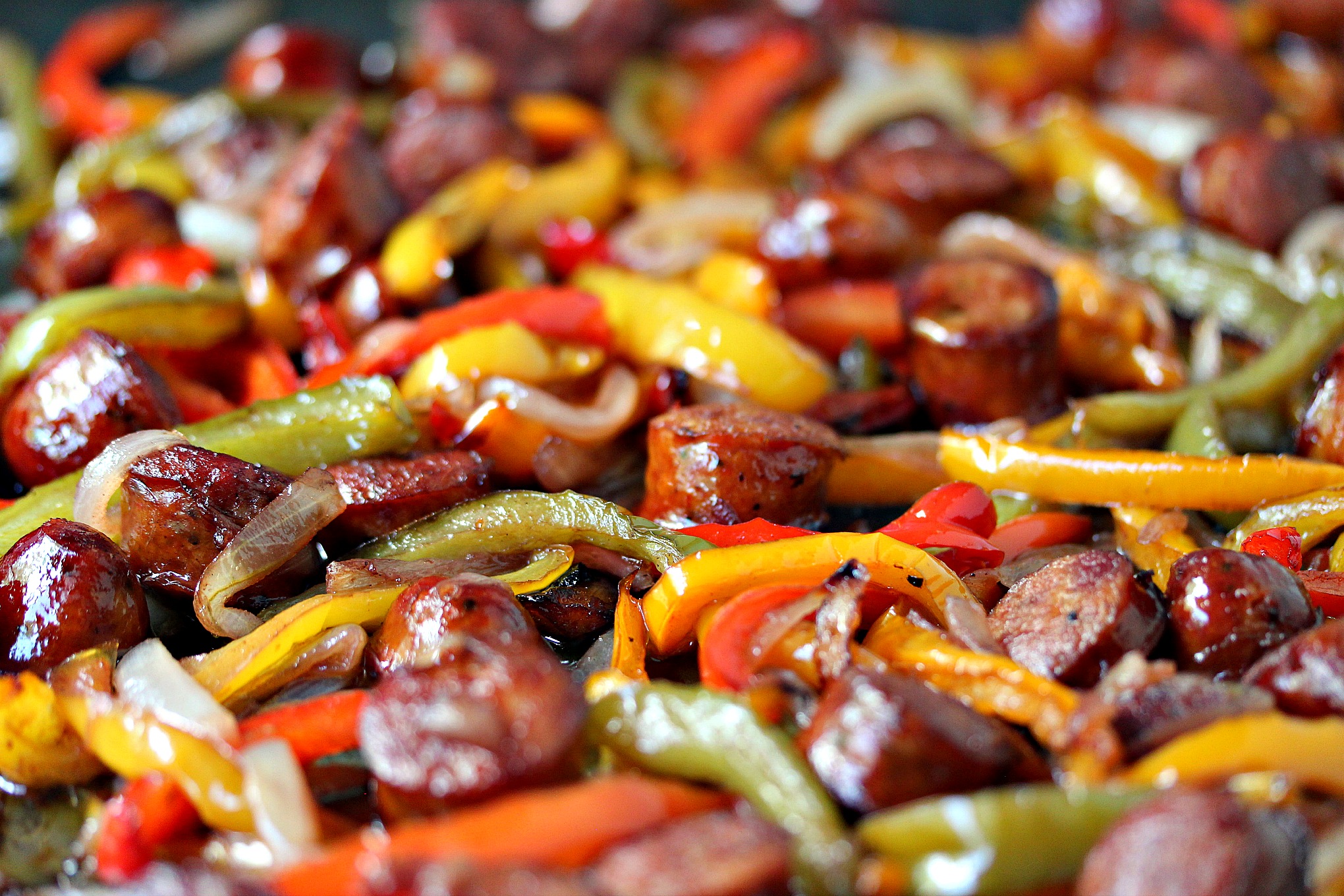 Sheet Pan Sausage and Peppers from cravingsofalunatic.com- This recipe is simple to make yet full of flavour. It's perfect to eat on its own, or pile it high on a hoagie bun. One pan, a few simple ingredients, and you have the perfect lunch or dinner recipe. (@CravingsLunatic)