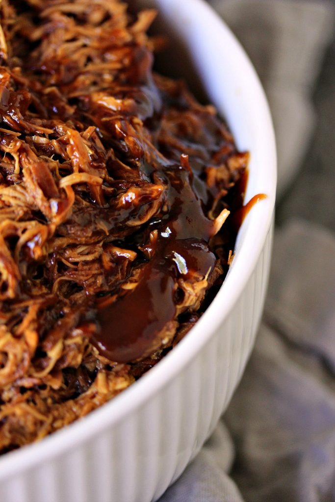 Slow Cooker Pulled BBQ Chicken in a white bowl.