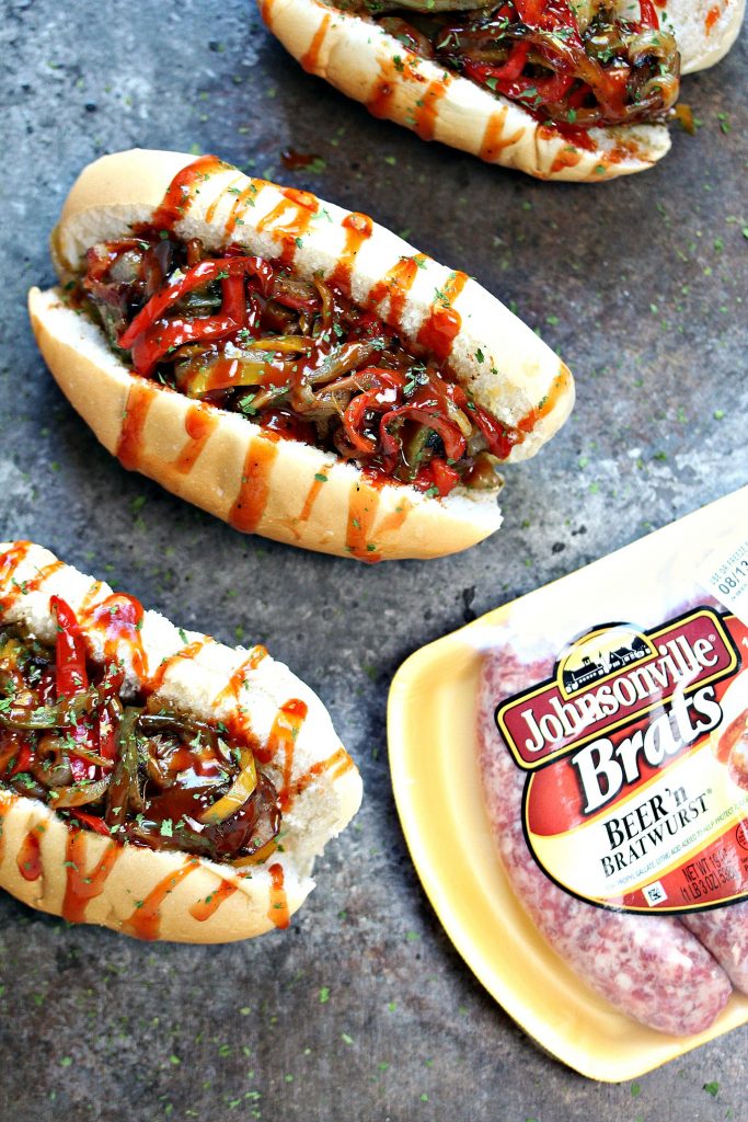 Grilled Bacon-Wrapped Beer Brats with Drunken Peppers and Onions from cravingsofalunatic.com- These Grilled Bacon-Wrapped Beer Brats with Drunken Peppers and Onions combine all of your favourite food in one delicious recipe. Fire up that grill and enjoy an epic dinner. @CravingsLunatic
