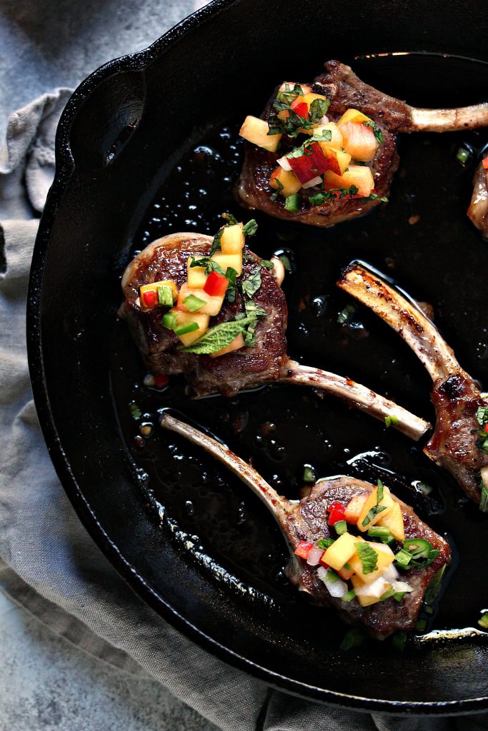 Lamb Lollipops with Peach Salsa from cravingsofalunatic.com- This lamb lollipop recipe is quick and easy, yet packed with flavour. The lamb is seared, then topped with an easy peach salsa recipe. A stunning meal on the table in under 20 minutes. @CravingsLunatic