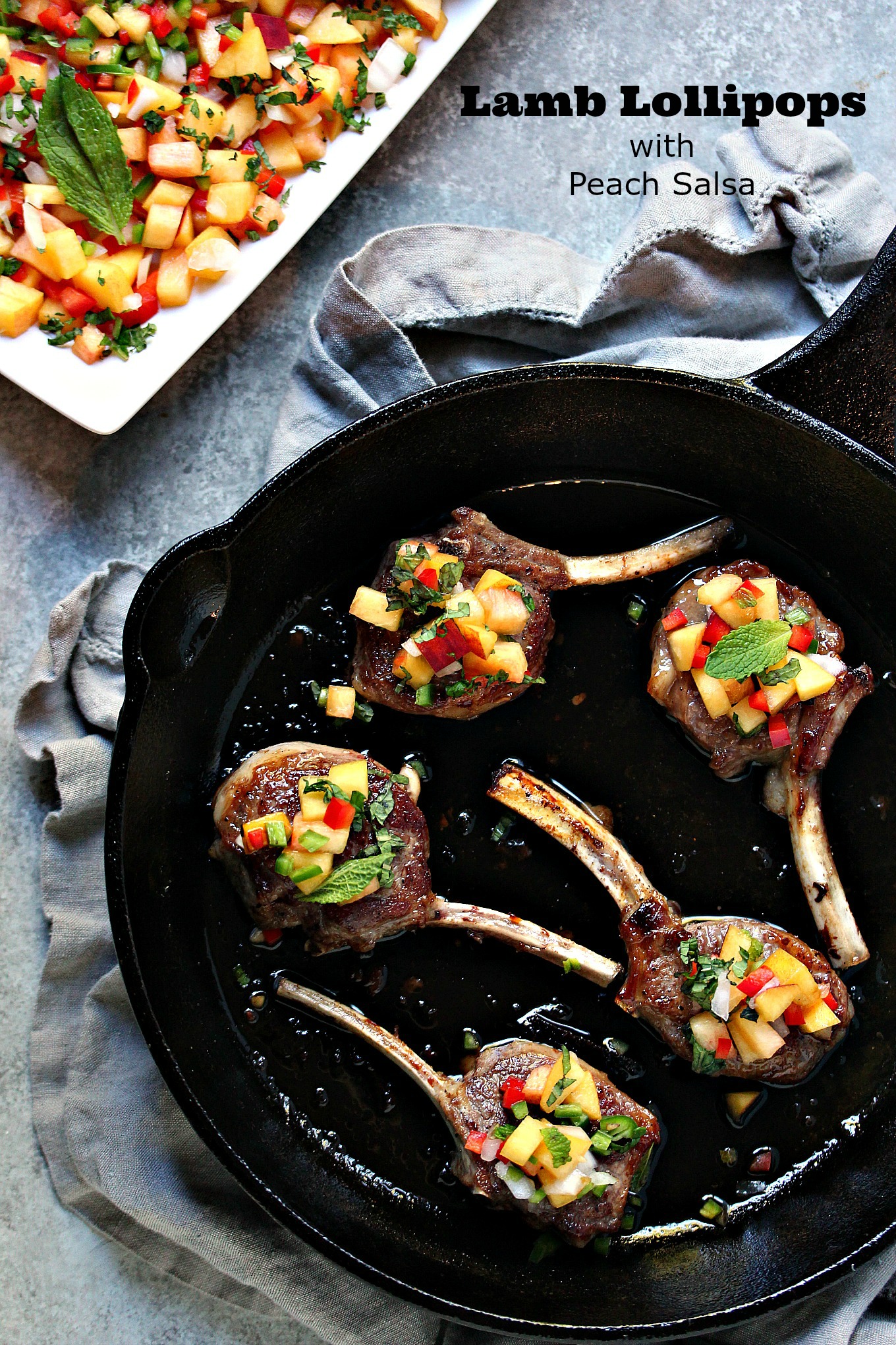 Lamb Lollipops with Peach Salsa - This lamb lollipop recipe is quick and easy, yet packed with flavour. The lamb is seared, then topped with an easy peach salsa recipe. A stunning meal on the table in under 20 minutes.