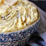 Slow Cooker Garlic Mashed Potatoes served in a blue stoneware bowl.