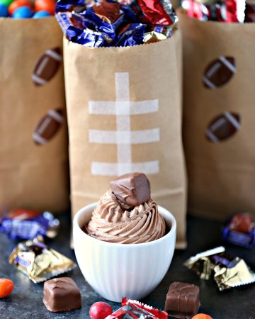 Chocolate Cheesecake Dip from cravingsofalunatic.com- This easy recipe for Chocolate Cheesecake Dip is perfect for game day. Whip up a batch today and serve with Snickers and M&M's in fun football themed snack bags.
