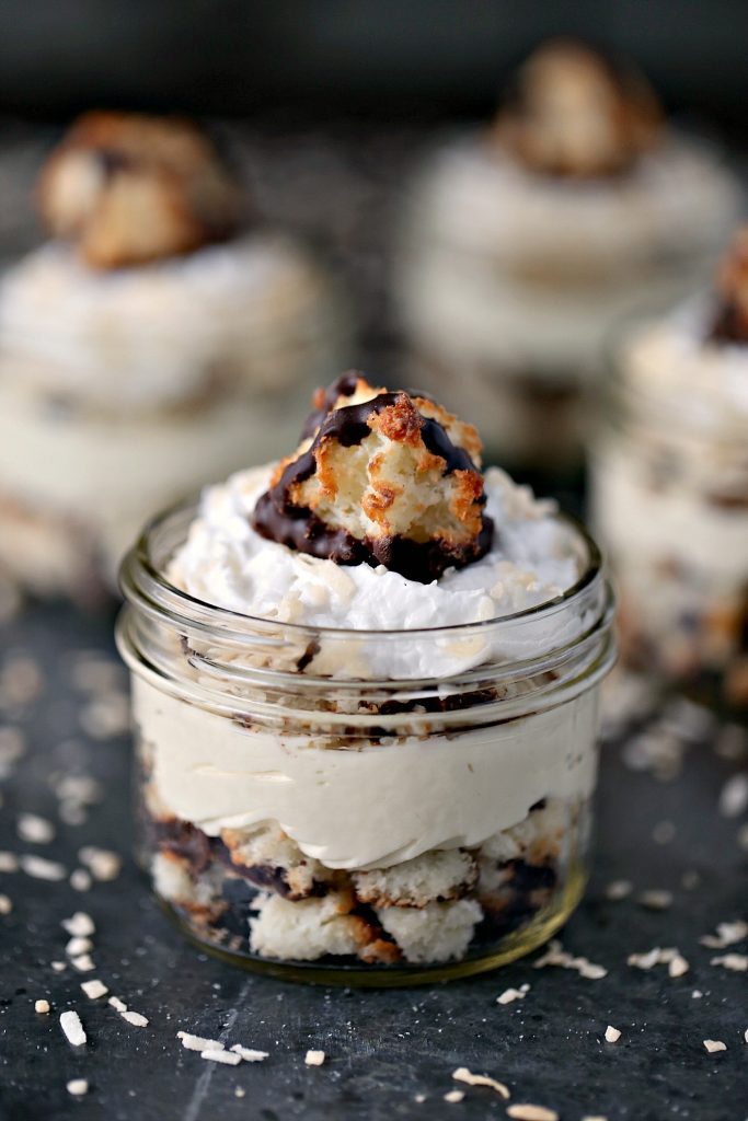 Coconut Macaroon Cheesecake Parfaits from cravingsofalunatic.com- Layers of coconut macaroons, coconut cheesecake filling, toasted coconut, and coconut whipped cream. All topped off with a coconut macaroon cookie! @CravingsLunatic