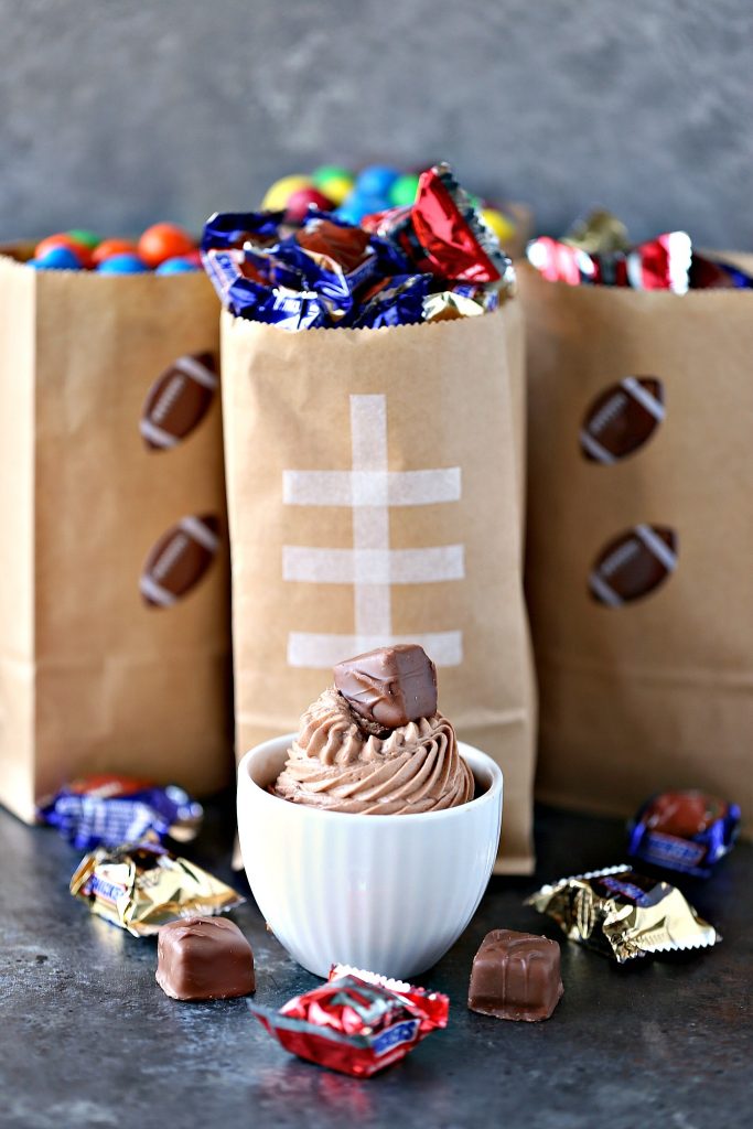 Chocolate Cheesecake Dip from cravingsofalunatic.com- This easy recipe for Chocolate Cheesecake Dip is perfect for game day. Whip up a batch today and serve with Snickers and M&M's in fun football themed snack bags.