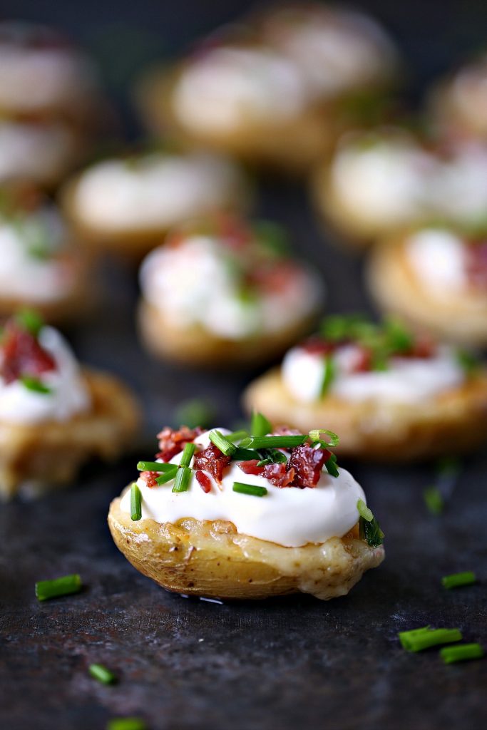 Mini Potato Skins with Sour Cream, Bacon, and Chives from cravingsofalunatic.com- This recipe for Mini Potato Skins with Sour Cream, Bacon, and Chives is simple and delicious. These little bites are perfect for entertaining, especially during game season.