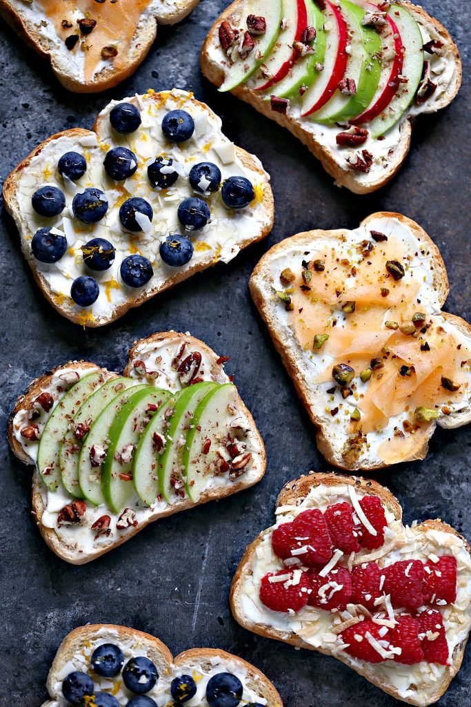 Breakfast Toast- 4 Ways: Breakfast Toast with Cantaloupe, Pistachios, and Honey. Breakfast Toast with Apples, Pecans, and Honey. Breakfast Toast with Raspberries, Coconut, and Honey. Breakfast Toast with Blueberries, Coconut Chips, and Honey. Visit cravingsofalunatic.com for more great recipes.