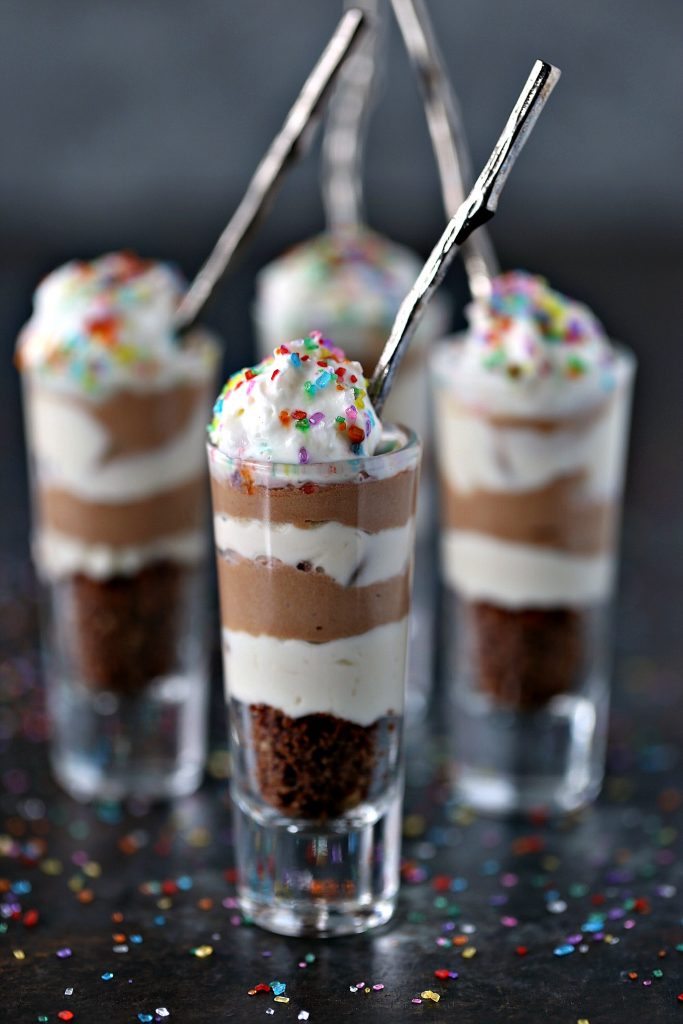 No Bake Chocolate Coffee Mini Cheesecakes in tall shot glasses with silver spoons in each glass
