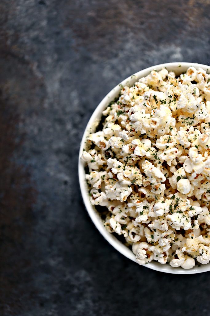 Parmesan Popcorn Recipe from cravingsofalunatic.com- Enjoy a late afternoon treat with this Parmesan Popcorn recipe. Air-popped popcorn topped with parmesan cheese and dried parsley. Perfect for an afternoon treat!