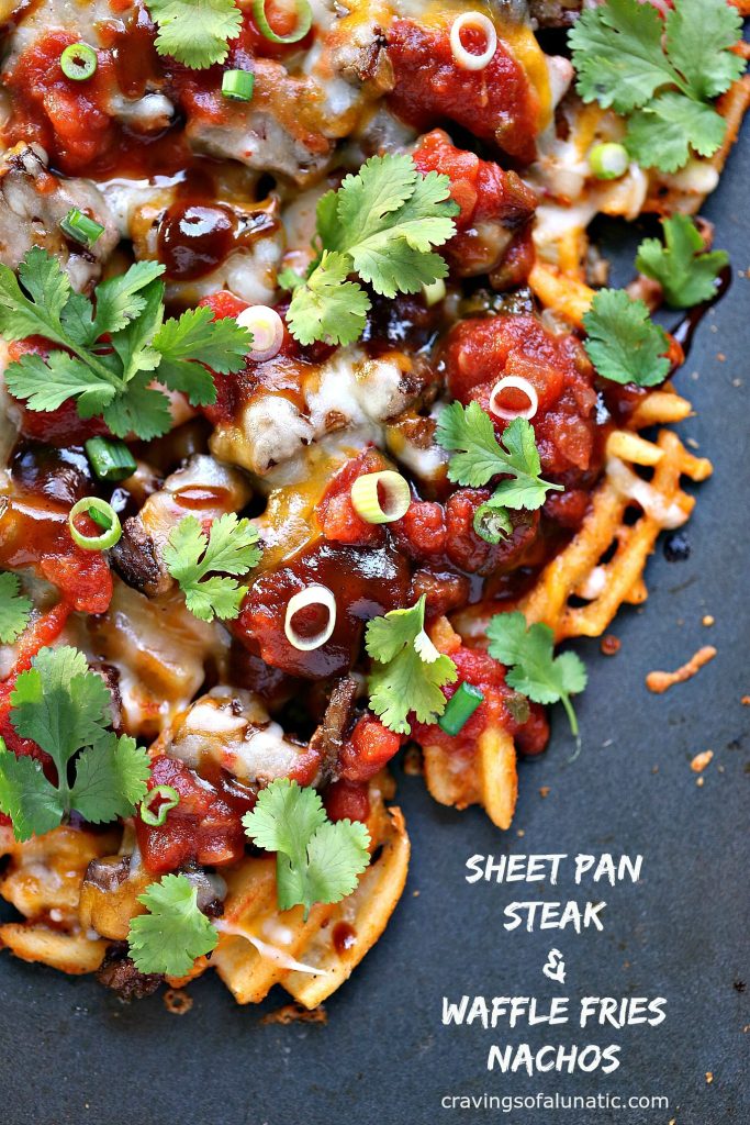 Sheet Pan Steak and Waffle Fry Nachos from cravingsofalunatic.com- These loaded nachos are made with waffle fries, steak and Tex-Mex cheese then topped with barbecue sauce, salsa, onions, and cilantro. All cooked on a sheet pan to make clean up a snap.