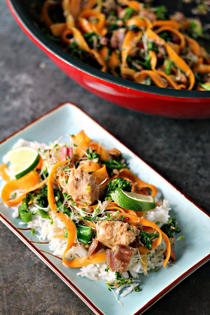 Easy Tuna Stir Fry Bowls on a light blue plate with wok in the background.