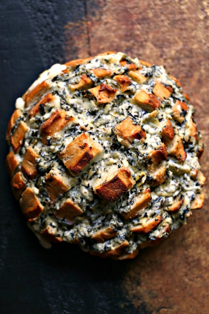 Spinach-Artichoke Cheesy Bread from cravingsofalunatic.com- This recipe is chock full of flavor yet remarkably easy to make. The bread is stuffed with spinach artichoke dip and cheese. You need to make this bread immediately. 