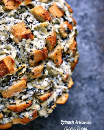 Spinach-Artichoke Cheesy Bread from cravingsofalunatic.com- This recipe is chock full of flavor yet remarkably easy to make. The bread is stuffed with spinach artichoke dip and cheese. You need to make this bread immediately.