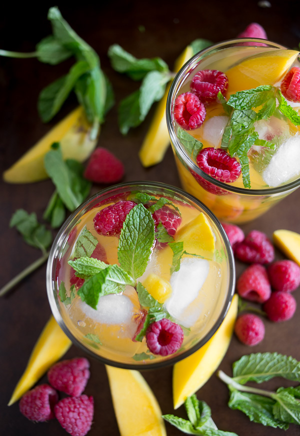 Raspberry Mango Sangria from Nutmeg Nanny- featured on The Best Sangria Recipes by cravingsofalunatic.com- Celebrate summer in epic style with The Best Sangria Recipes! Sangria is so easy to make and super versatile. Whip up a batch today!