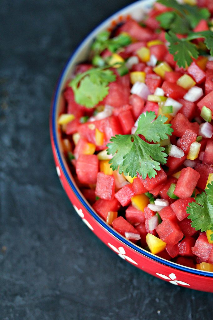 Overhead image of watermelon salsa in a brightly coloured bowl.