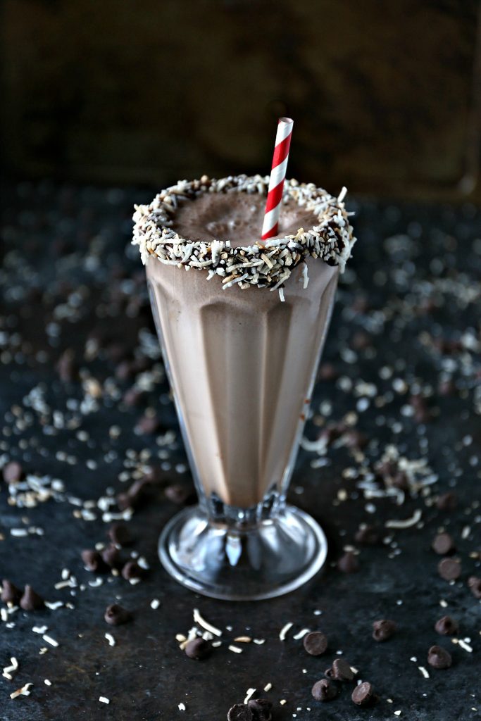 Chocolate Coconut Milkshake served in a milkshake glass with the rim dipped in chocolate and coconut.