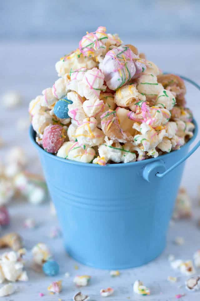 close up image Easter Rocky Road Popcorn from Barbara Bakes in a blue bucket
