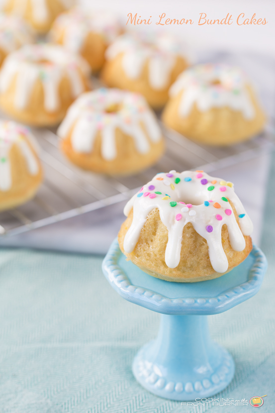 image of Mini Lemon Bundt Cakes from Cooking on the Front Burner on a mini blue cake stand and on pan