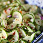 thai cucumber salad in a blue and white bowl